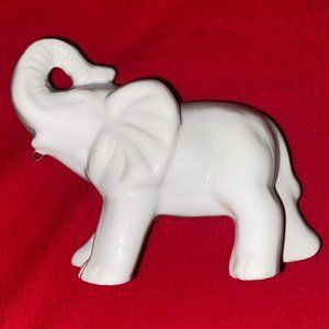 Porcelain White elephant with trunk up.